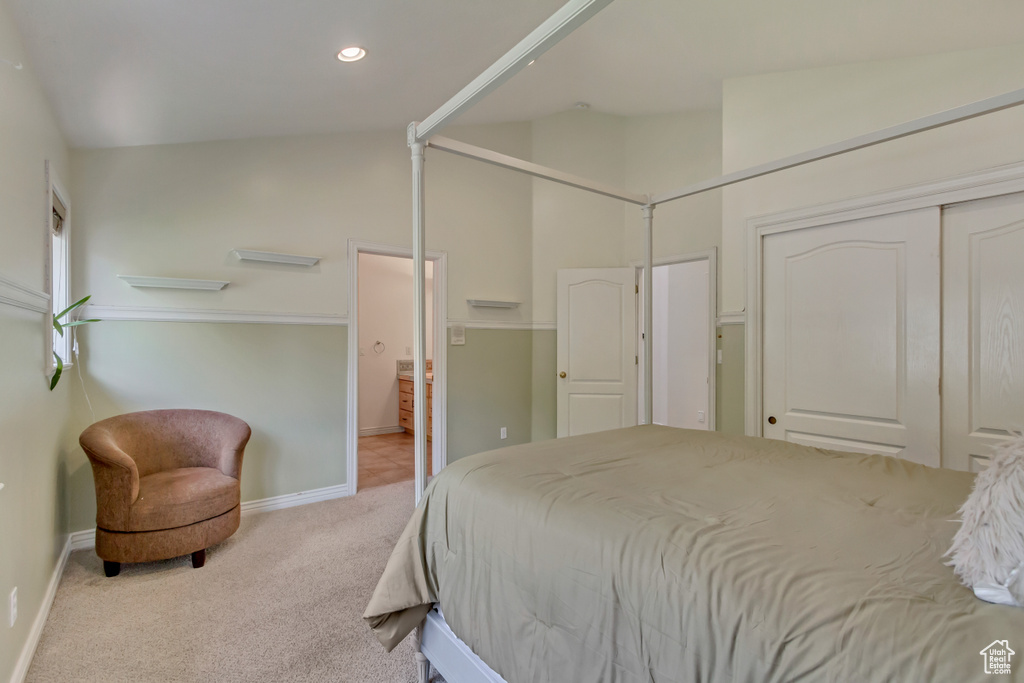Carpeted bedroom featuring baseboards, recessed lighting, ensuite bath, and a closet