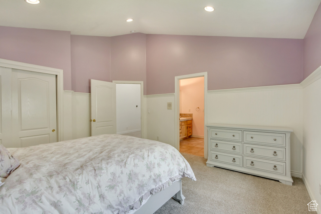Bedroom featuring light carpet, a closet, recessed lighting, and ensuite bath