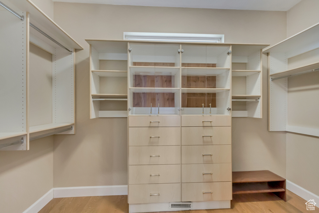 Spacious closet with visible vents and light wood-style flooring