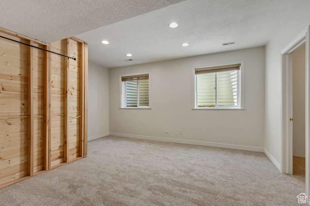 Unfurnished bedroom featuring recessed lighting, baseboards, and light carpet
