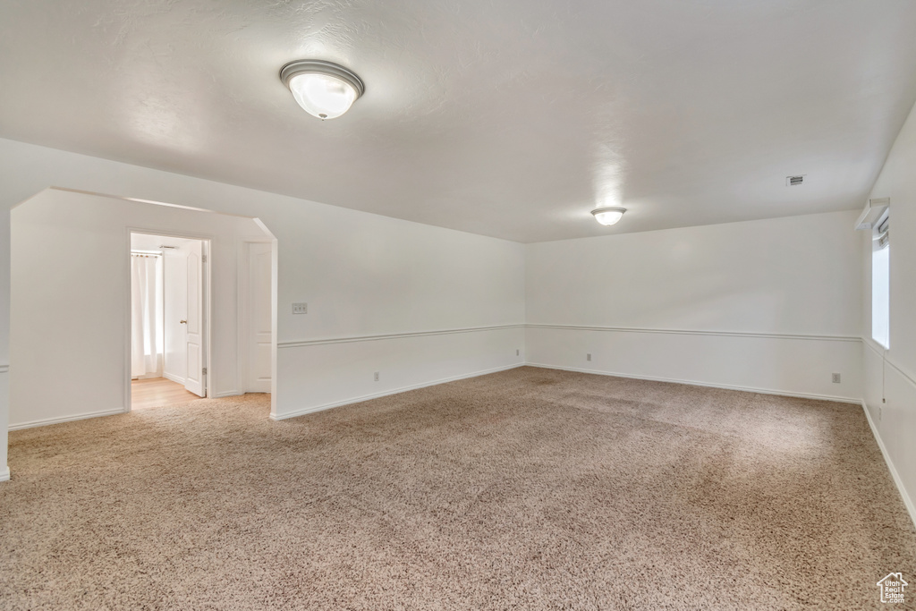 Empty room with baseboards and light carpet