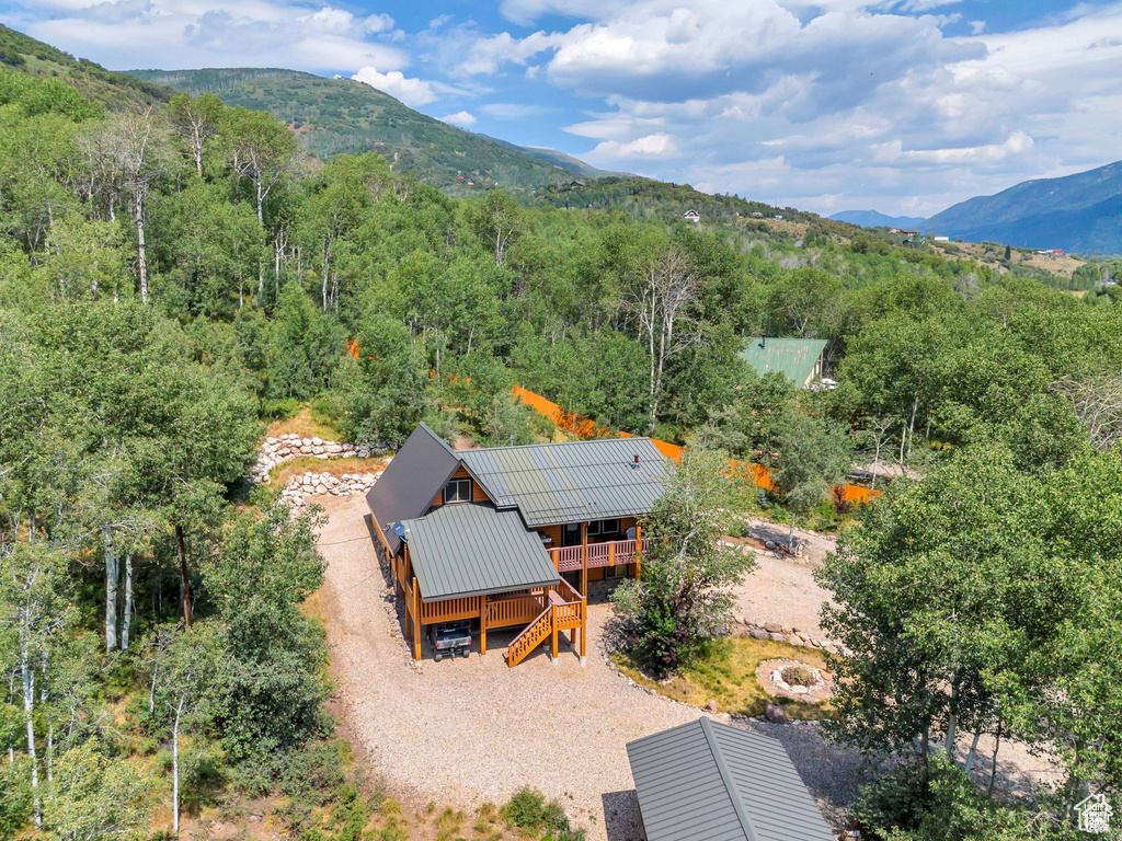 Drone / aerial view featuring a mountain view and a wooded view