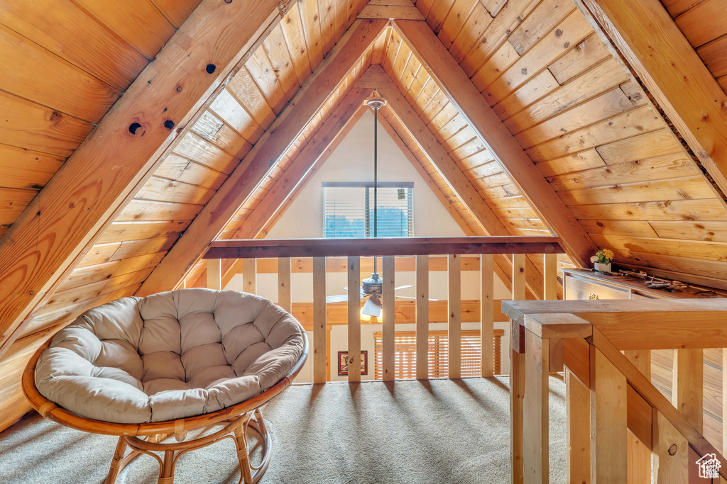 Sitting room featuring wood ceiling, carpet, and vaulted ceiling