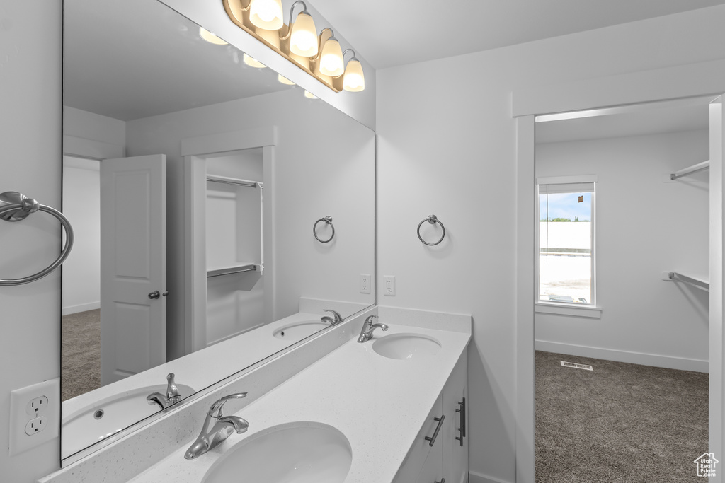 Full bathroom featuring double vanity and a sink