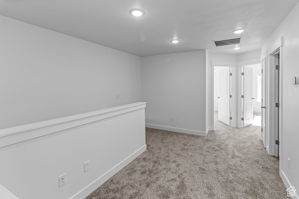 Corridor featuring baseboards, carpet flooring, visible vents, and recessed lighting