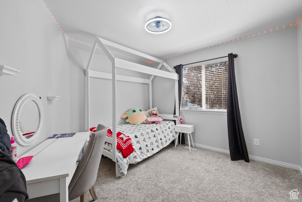 Carpeted bedroom featuring baseboards