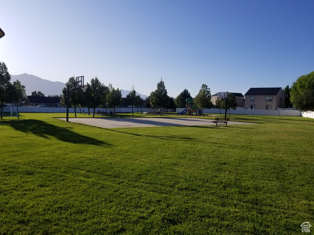 Surrounding community with community basketball court and a mountain view
