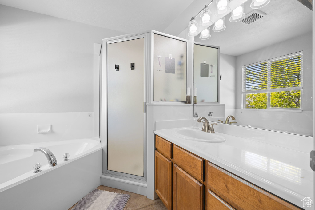 Full bath with a bath, a shower stall, visible vents, and vanity