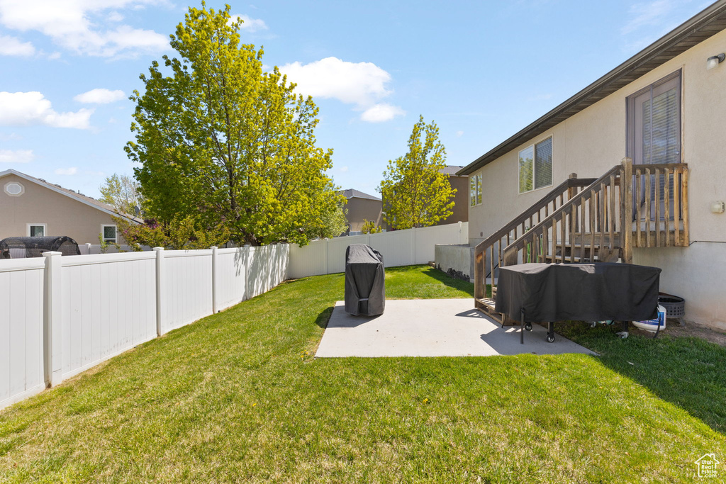 View of yard with a fenced backyard and a patio