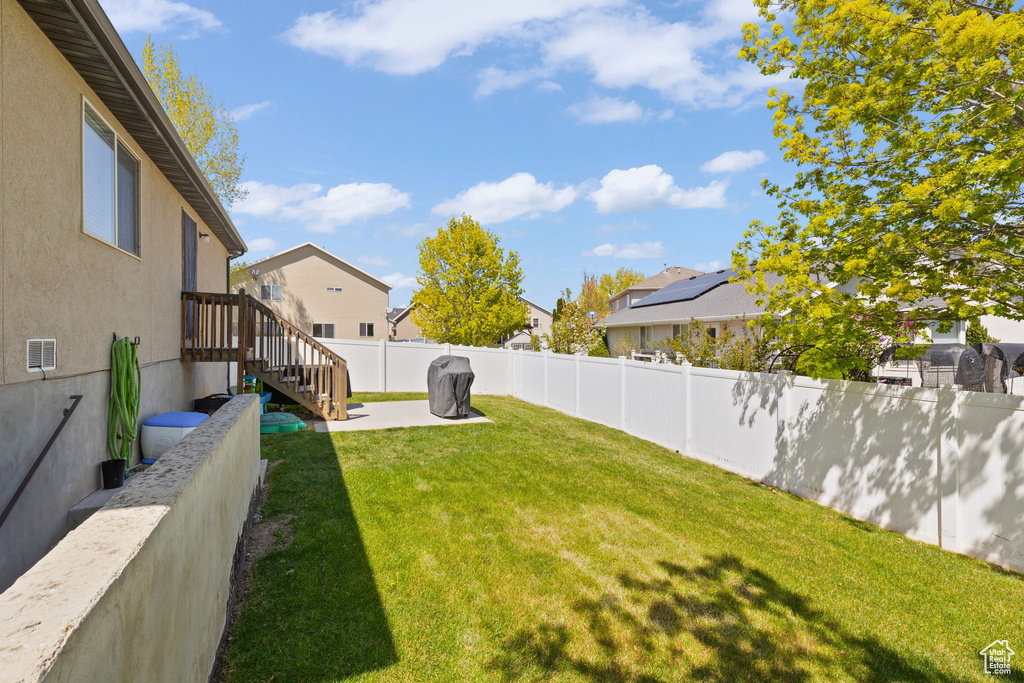 View of yard featuring a fenced backyard and a residential view