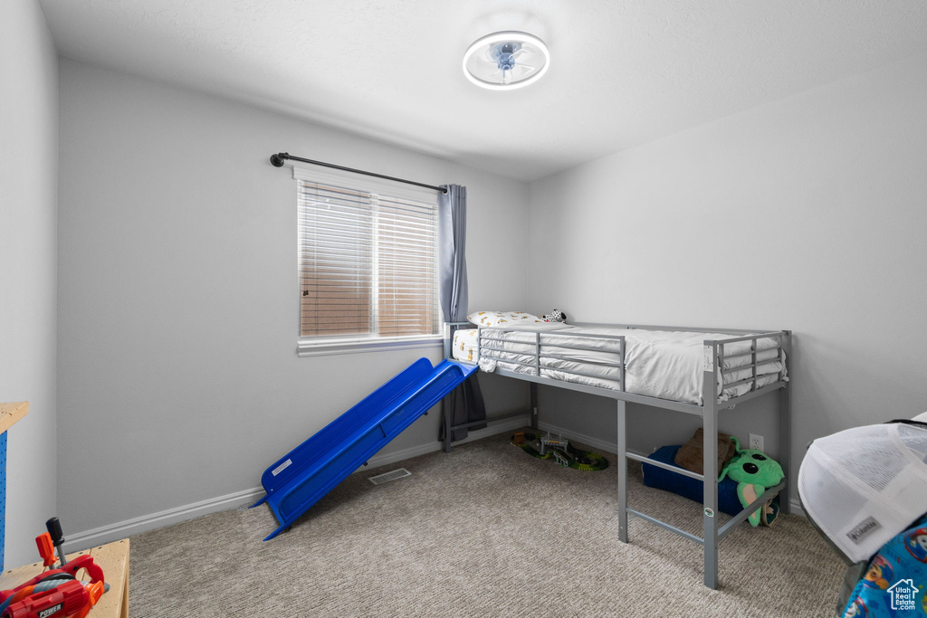 Carpeted bedroom with baseboards