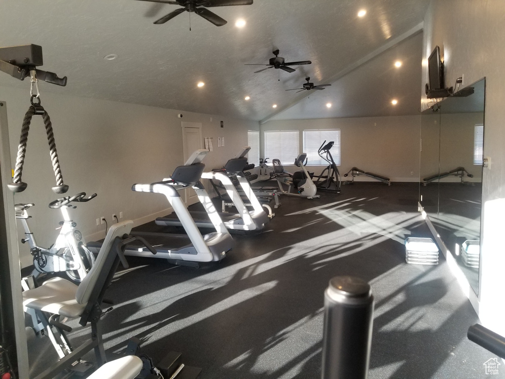 Exercise room with ceiling fan, recessed lighting, vaulted ceiling, and baseboards