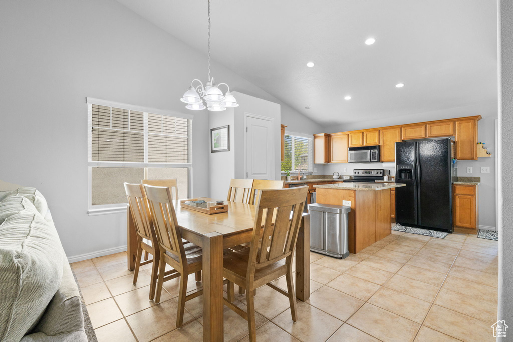 Dining room with recessed lighting, lofted ceiling, light tile patterned floors, baseboards, and a notable chandelier