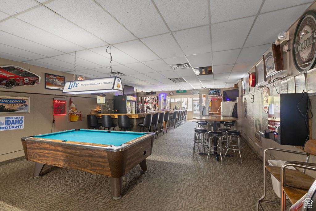 Playroom featuring carpet floors, a paneled ceiling, visible vents, and a bar