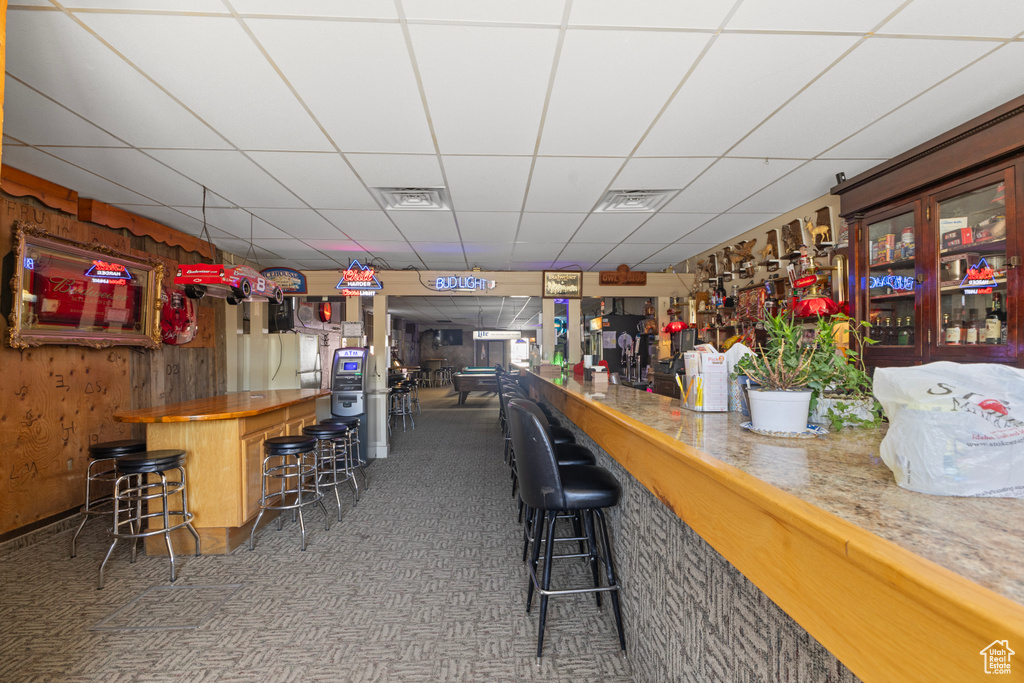 Bar with visible vents, a dry bar, a paneled ceiling, and carpet flooring