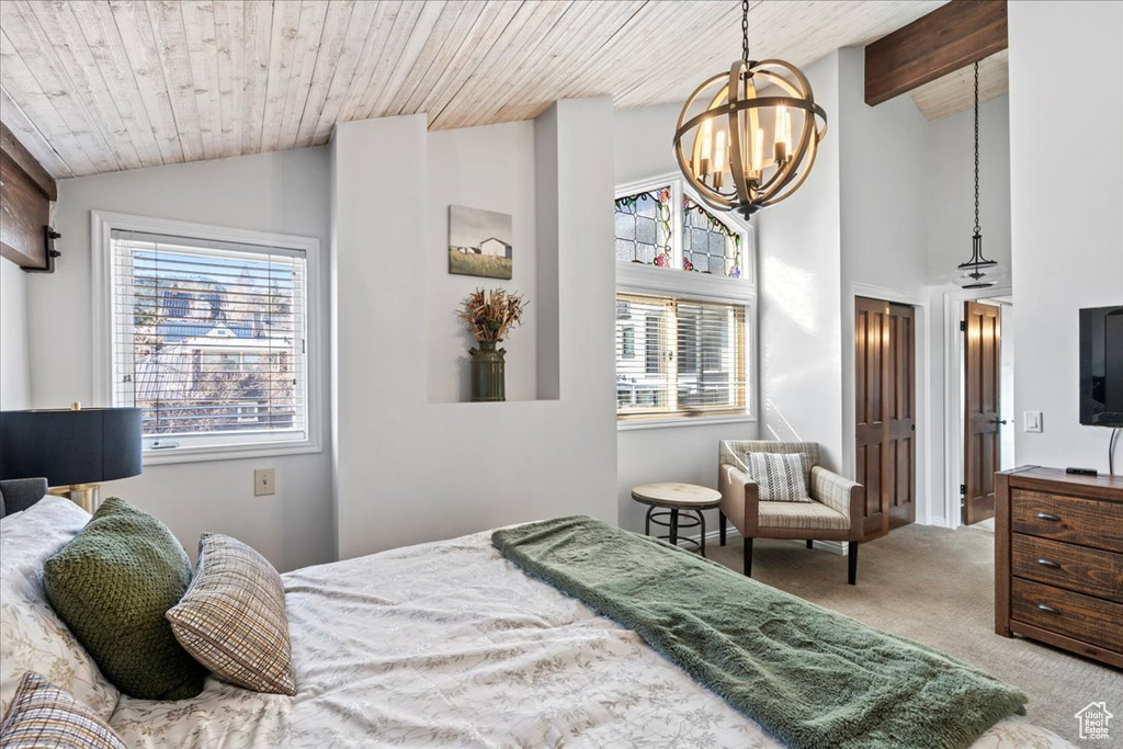 Bedroom featuring wood ceiling, carpet, a chandelier, and lofted ceiling