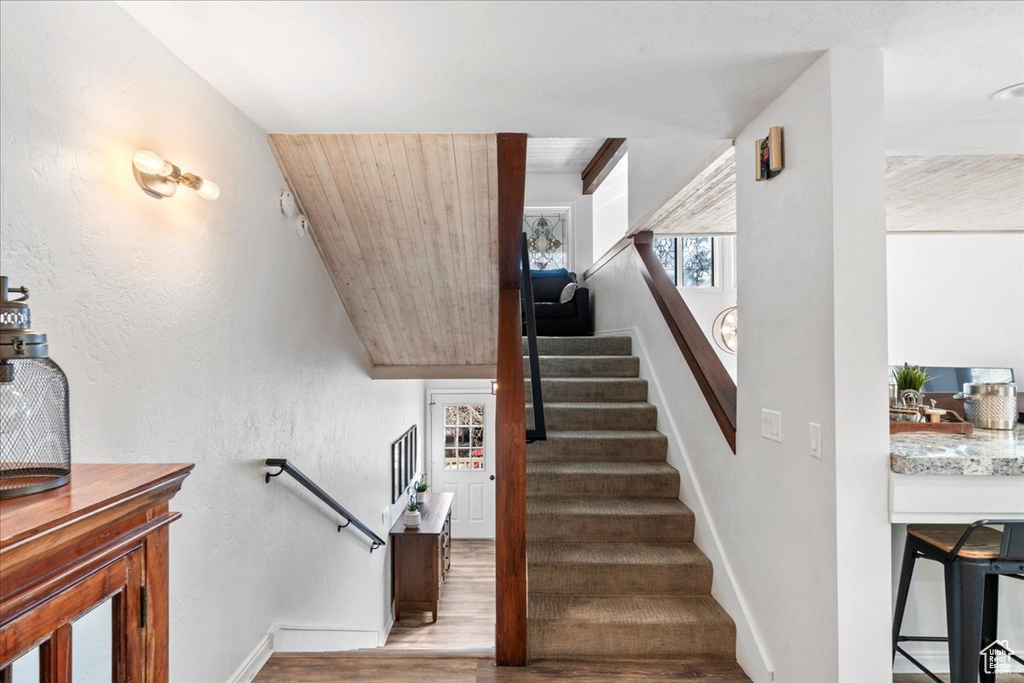 Stairs with baseboards and wood finished floors