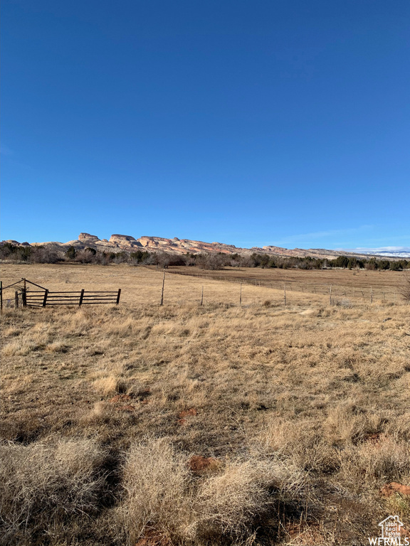 View of yard featuring fence and a rural view