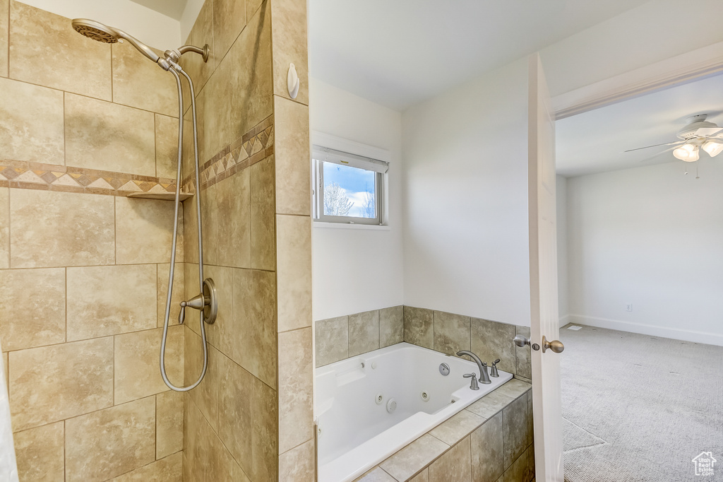 Bathroom with a tub with jets, a ceiling fan, and tiled shower