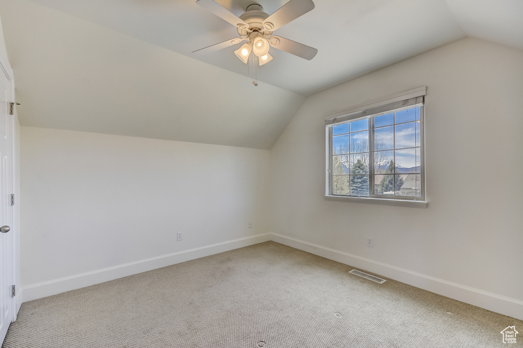 Bonus room featuring visible vents, carpet flooring, vaulted ceiling, and baseboards