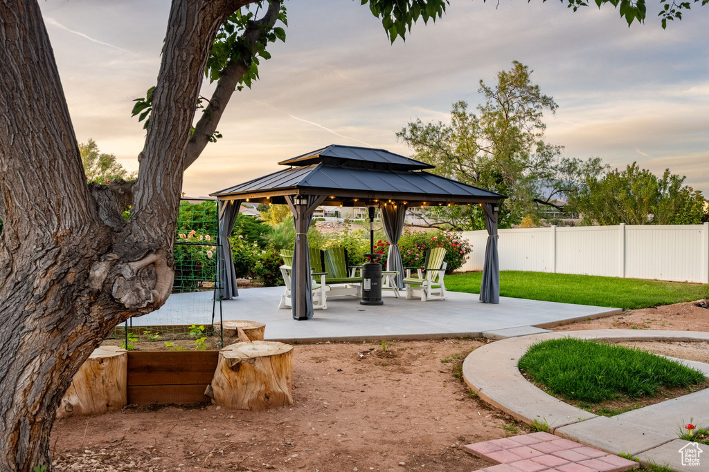 View of property's community with fence, a gazebo, and a patio area