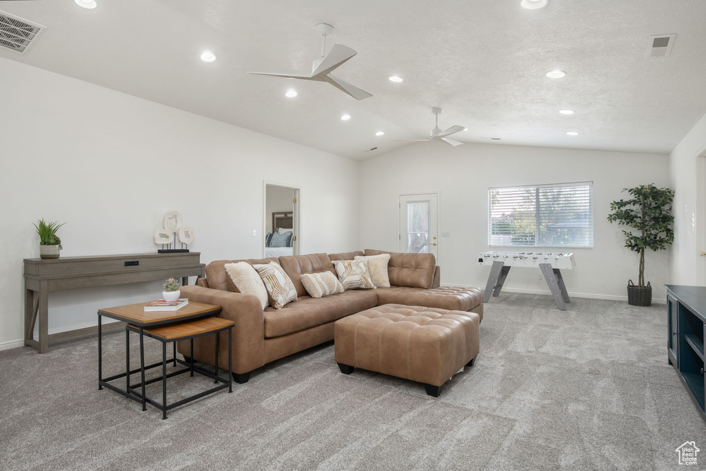 Living area with visible vents, recessed lighting, lofted ceiling, and light carpet