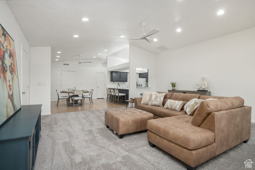 Living area with visible vents, lofted ceiling, light carpet, ceiling fan, and recessed lighting
