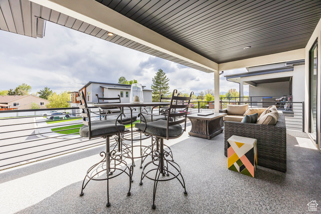 View of patio with a balcony