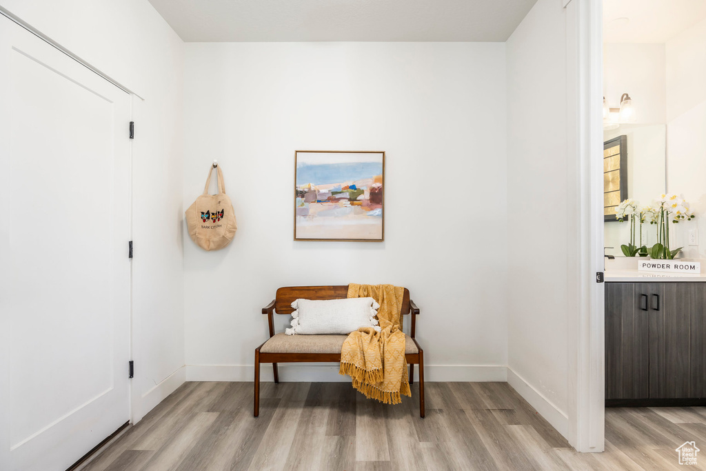 Living area with baseboards and light wood-type flooring