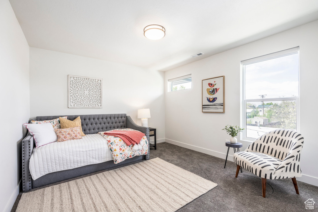 Carpeted bedroom featuring visible vents and baseboards
