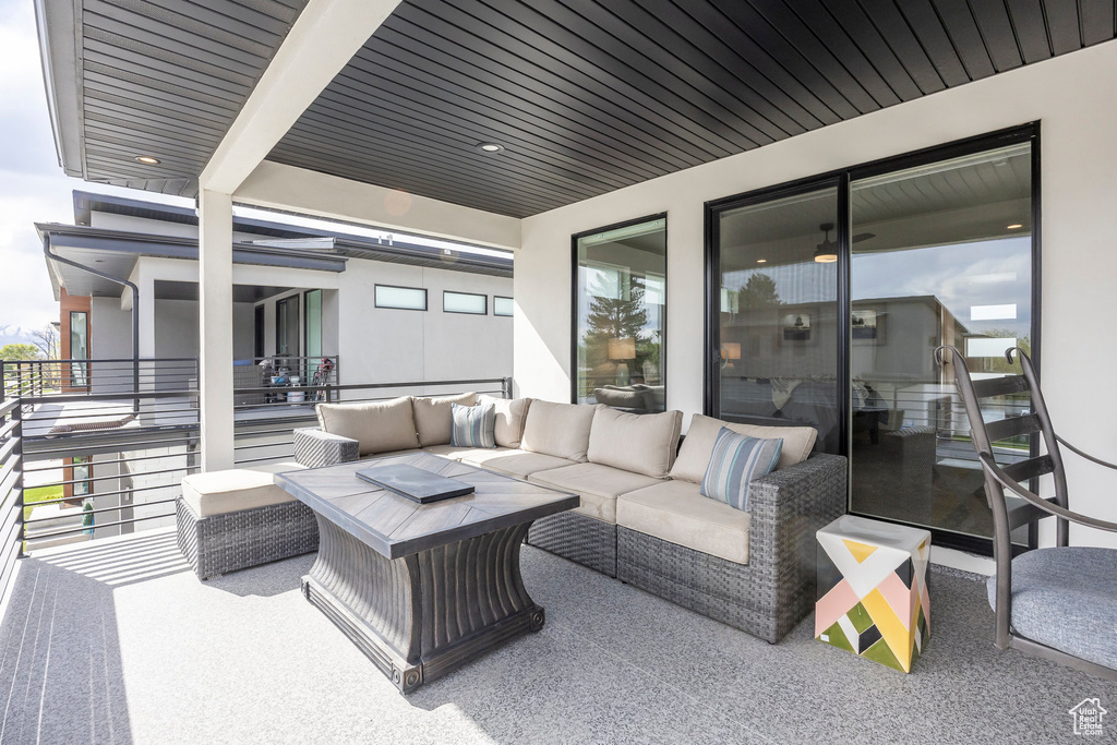 View of patio featuring an outdoor living space and a balcony