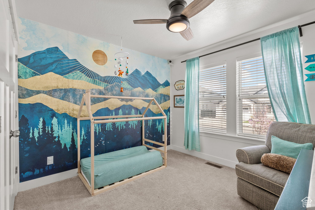 Carpeted bedroom featuring visible vents, baseboards, and ceiling fan