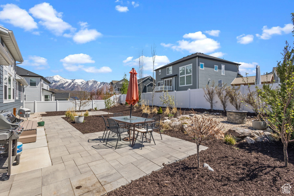 View of patio featuring a mountain view, a fenced backyard, and outdoor dining space