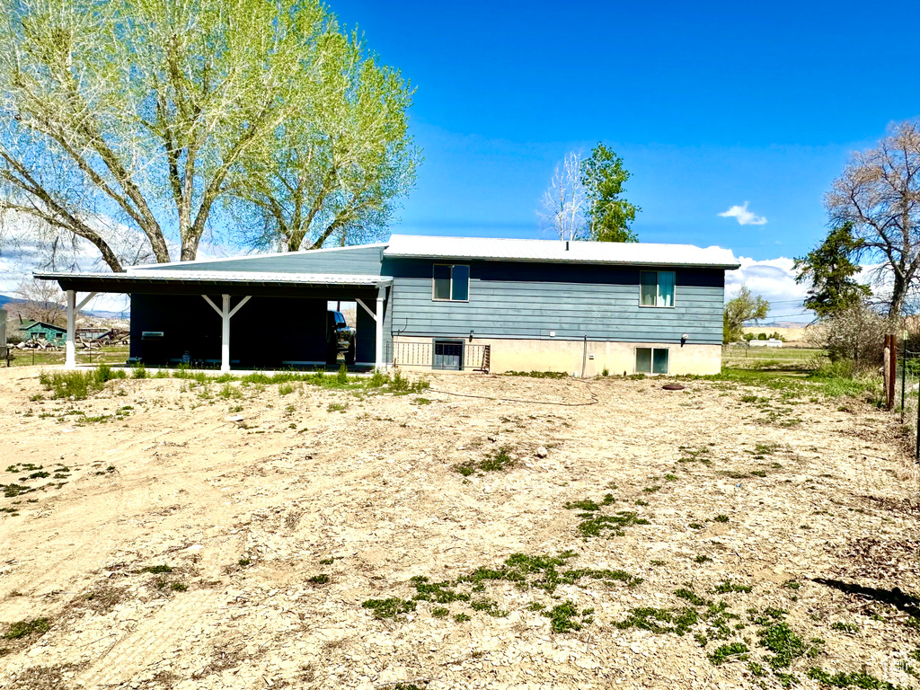 Back of house featuring a carport