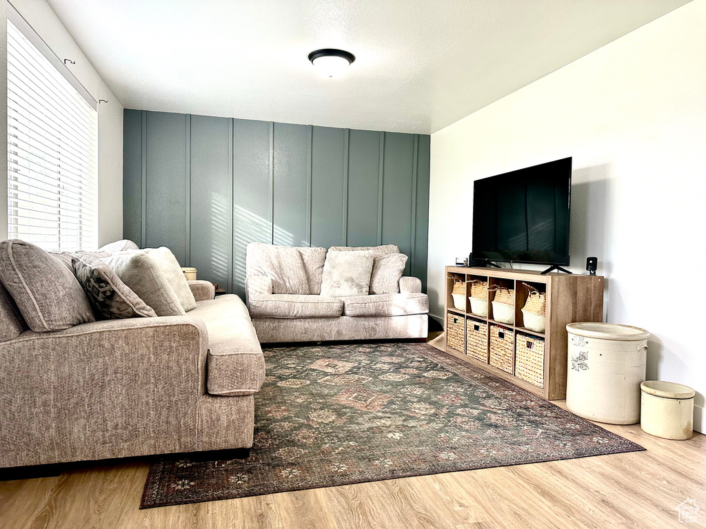 Living room with a decorative wall and wood finished floors