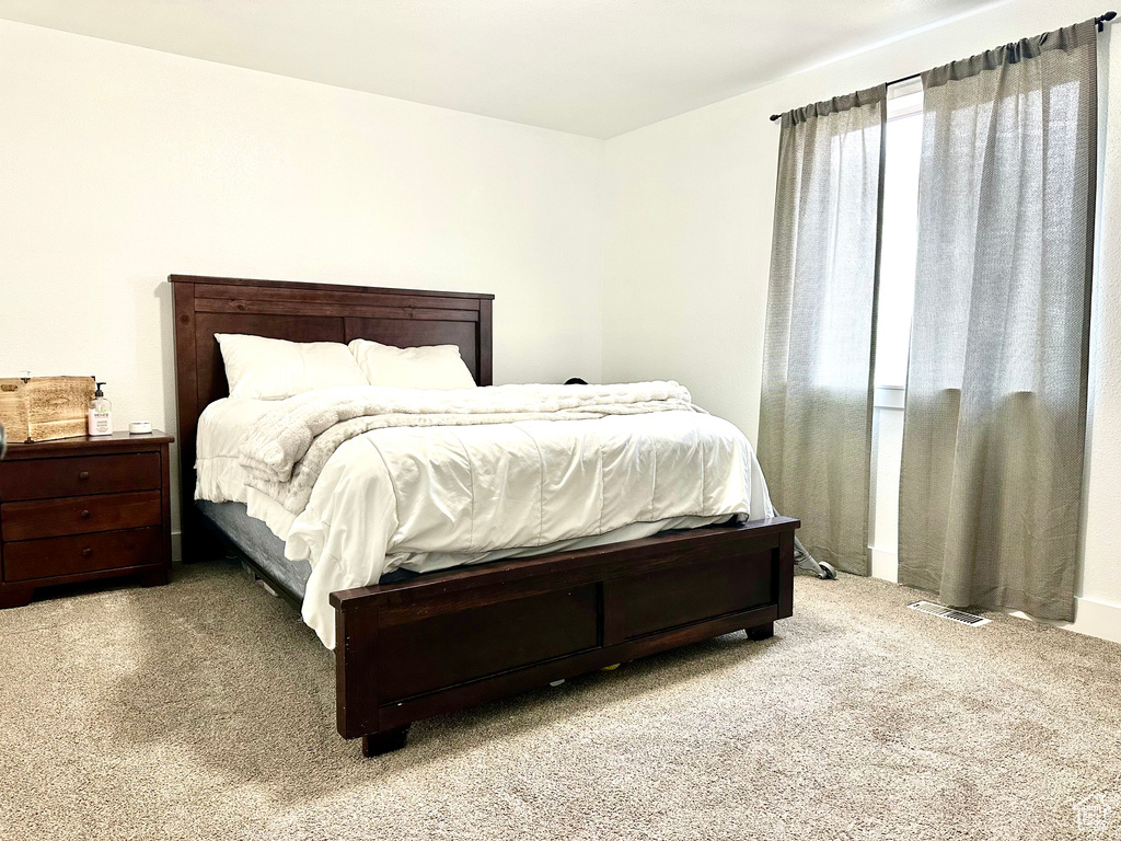 Carpeted bedroom with visible vents