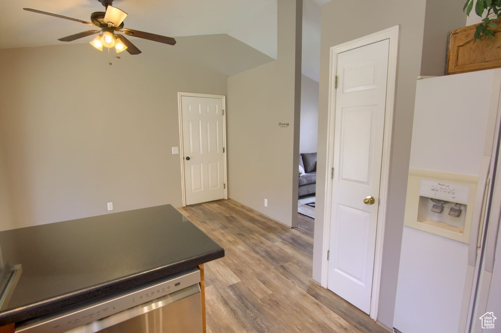 Interior space featuring light wood-style floors, white fridge with ice dispenser, a ceiling fan, and dishwasher