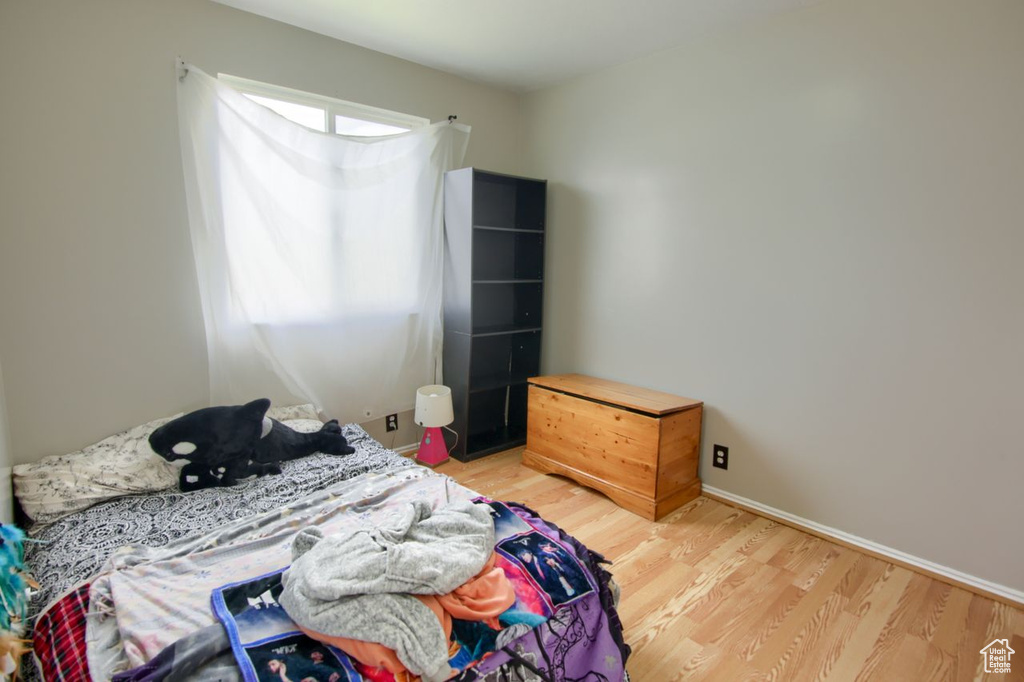 Bedroom with baseboards and light wood-style flooring