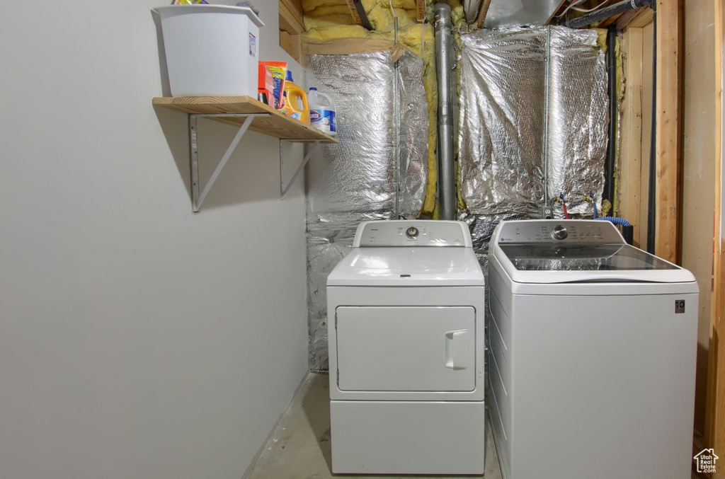 Washroom with laundry area and washing machine and clothes dryer