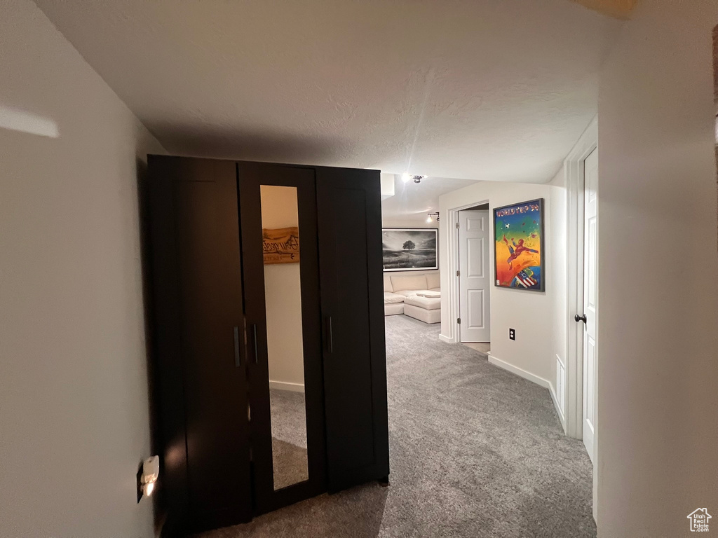Hallway featuring carpet flooring