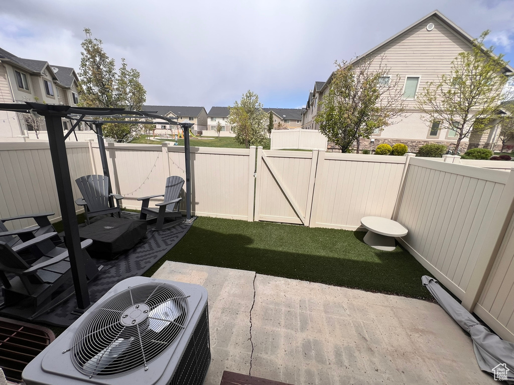 View of patio with a fenced backyard, central AC, and a residential view