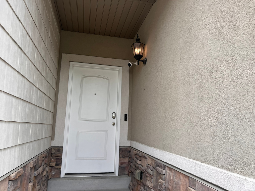 Property entrance with stucco siding and stone siding