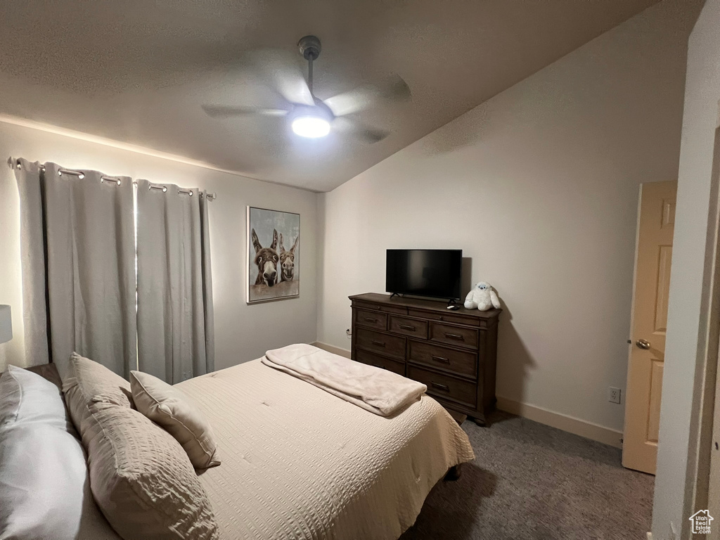 Bedroom featuring carpet flooring, ceiling fan, baseboards, and lofted ceiling