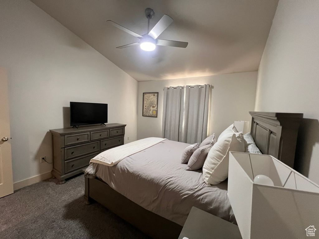 Bedroom with baseboards, a ceiling fan, carpet, and vaulted ceiling