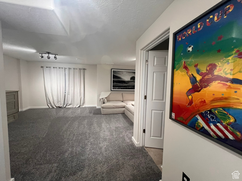 Interior space with baseboards and rail lighting