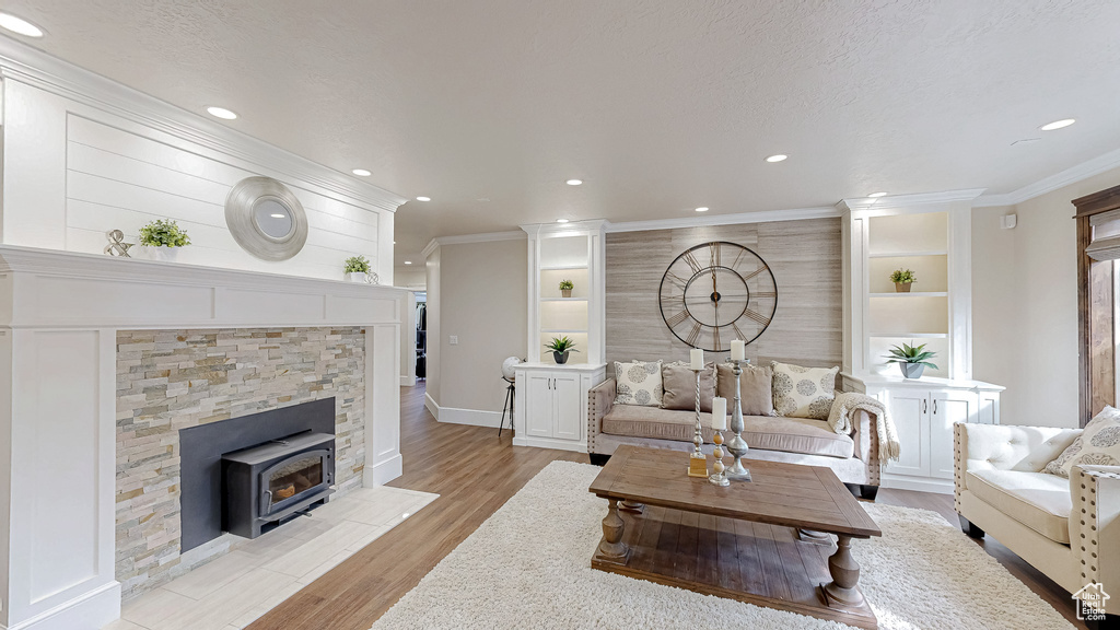Living area with recessed lighting, light wood finished floors, and baseboards