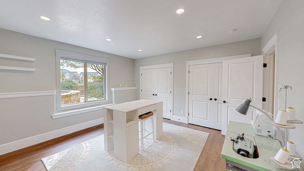 Office area with baseboards, recessed lighting, and wood finished floors