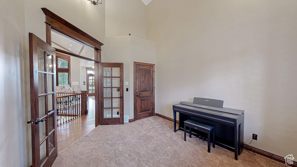 Interior space featuring baseboards, french doors, and carpet flooring