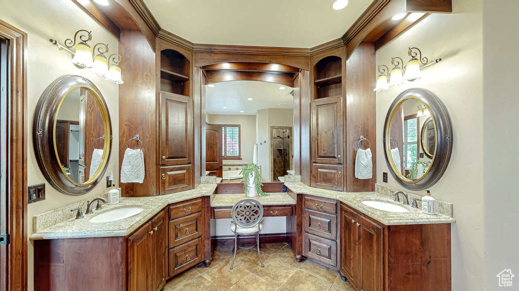 Full bathroom featuring double vanity, a sink, and tile patterned flooring