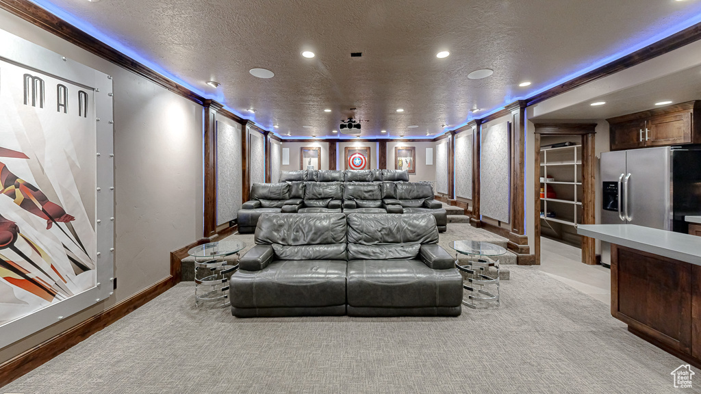 Cinema featuring recessed lighting, baseboards, light carpet, and a textured ceiling